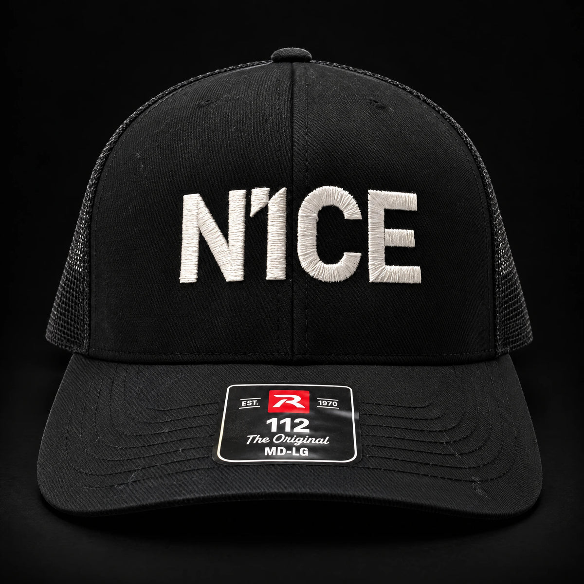 N1CE The Signature Trucker Cap in black, front view with embroidered N1CE logo