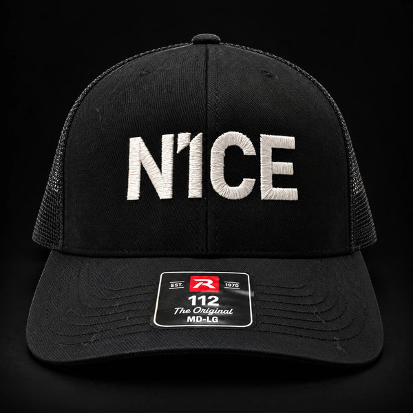 N1CE The Signature Trucker Cap in black, front view with embroidered N1CE logo